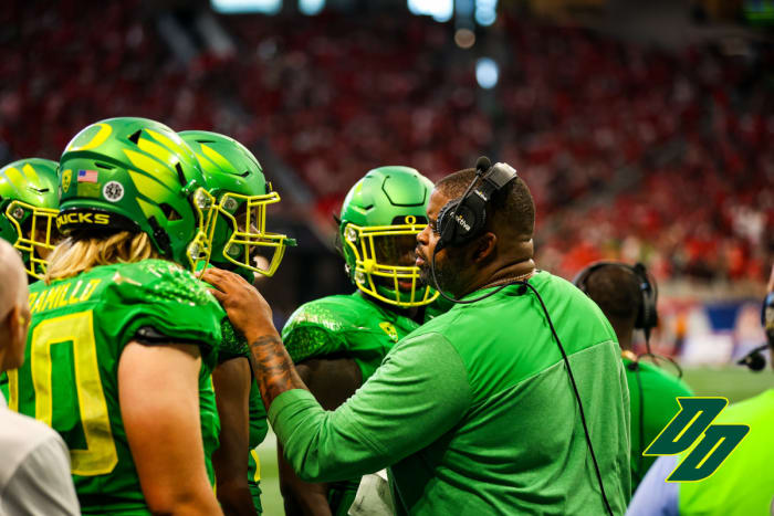 Oregon offensive line coach Adrian Klemm with Steven Jones during the 2022 Chick-Fil-A Kickoff game vs. the Georgia Bulldogs in Atlanta.